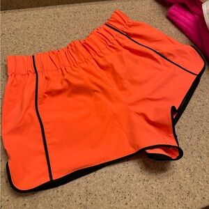 FP free people movement orange nylon athletic shorts black trim size small